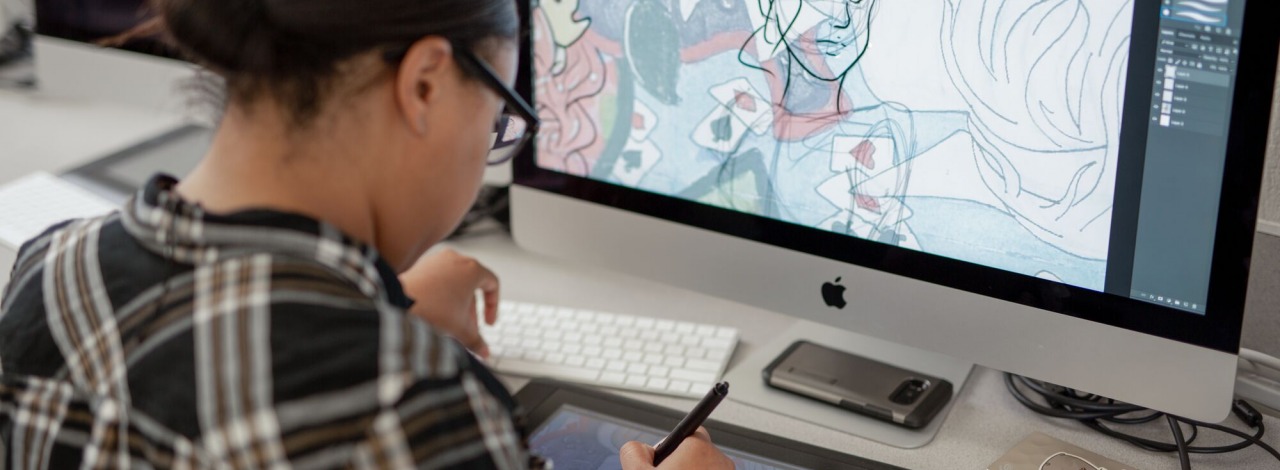 Close-up of a student drawing on a graphic tablet 