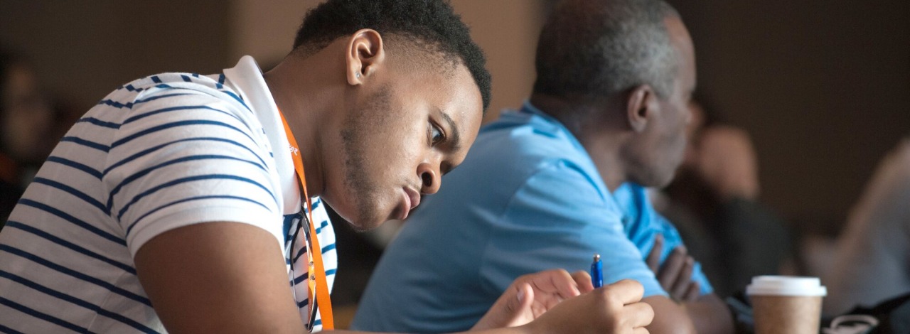 Male student taking notes at BBCB summit