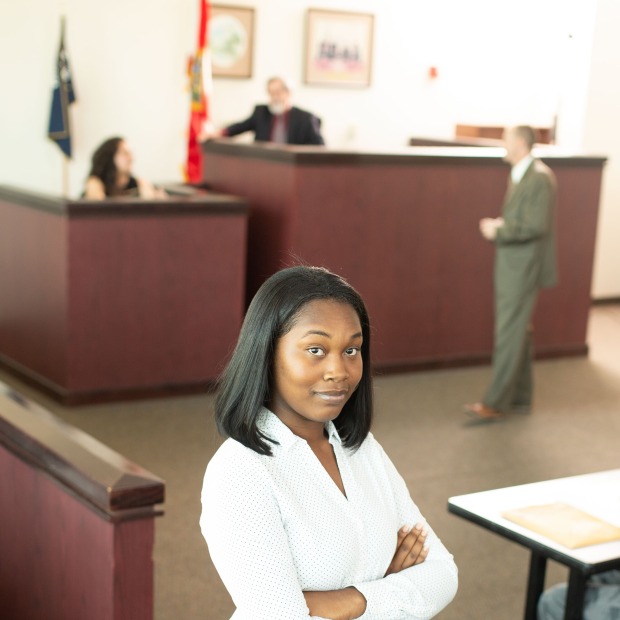 Paralegal student posing in front of courtroom