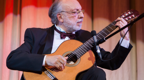 Photo of Jose Luis Merlin holding guitar