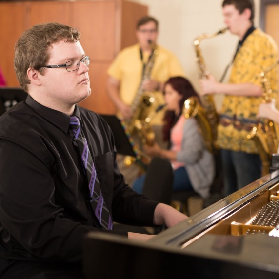 A group of music students playing musical instruments in class