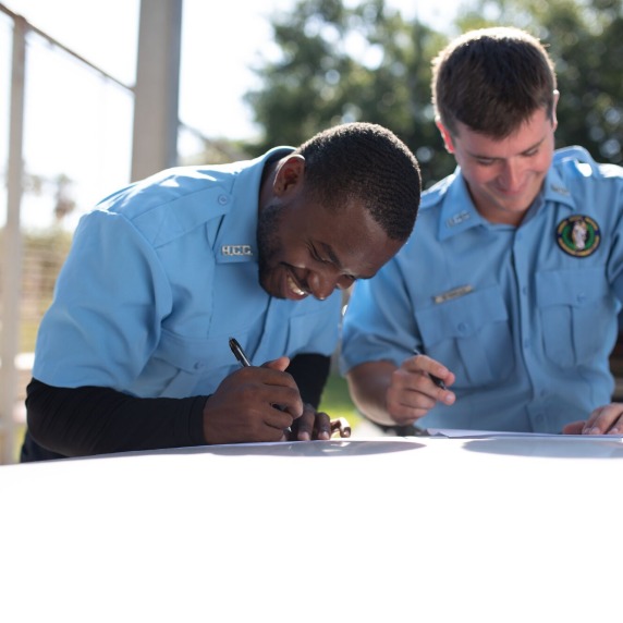 Filling out report outside with a coworker 