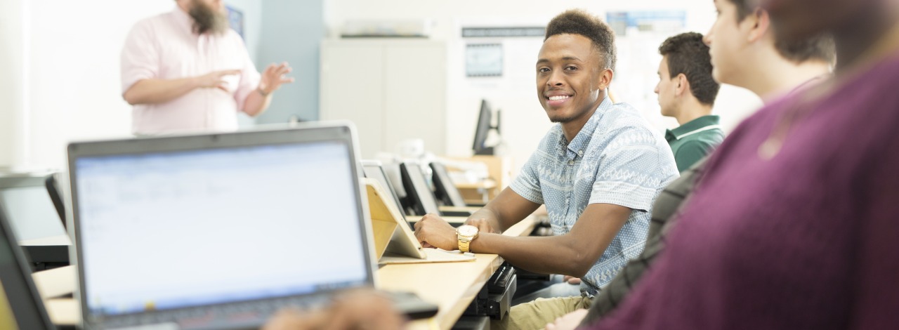 Students using laptops in a classroom during a lecture