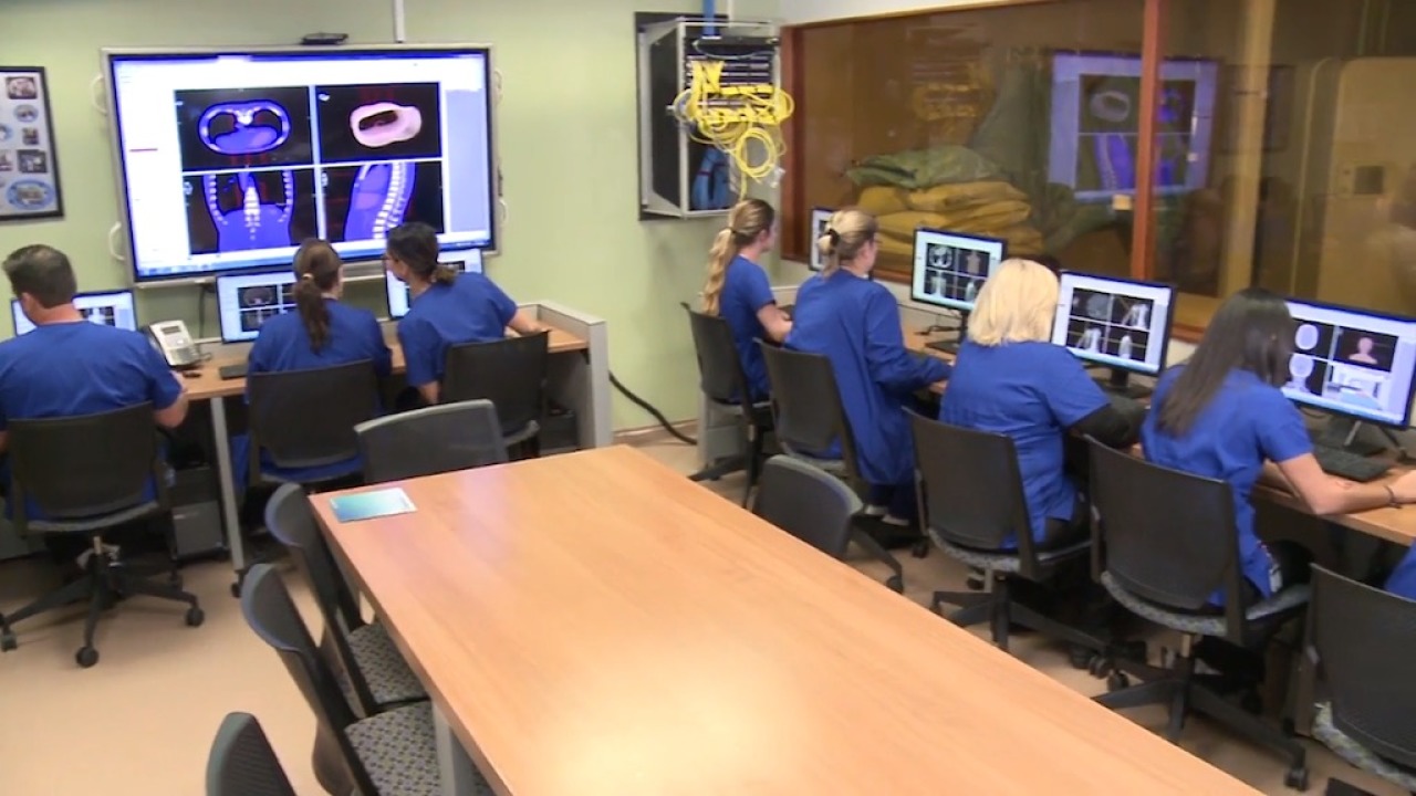 Group of students in blue scrubs in computer lab